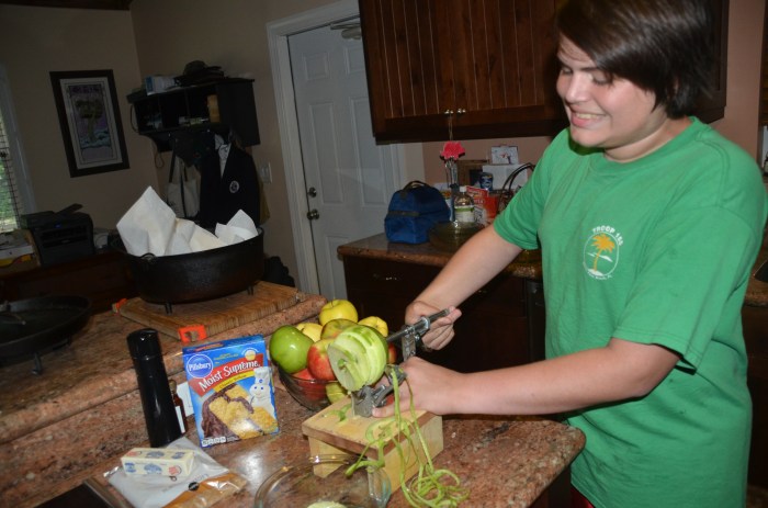Christopher cores and peels the apples.
